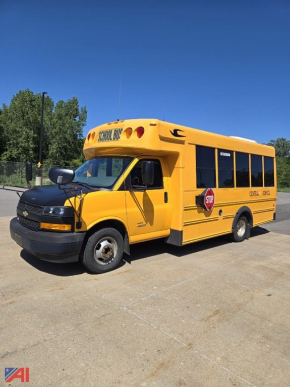 School bus exterior showing yellow 2018 Chevrolet Express G4500 mini school bus with stop sign and doors