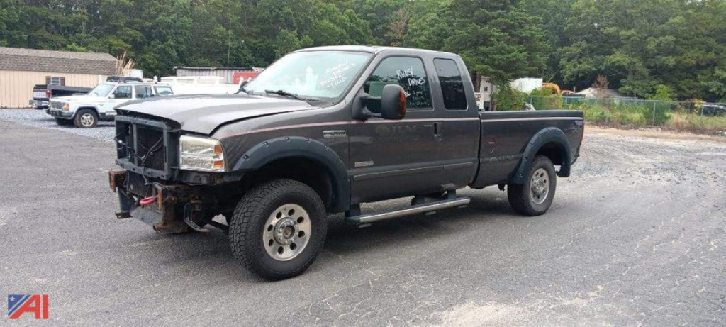 Ford F-250 Super Duty pickup with extended cab and single rear wheel showing front bumper winch mounting plate and side step