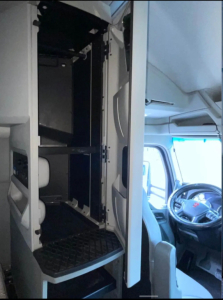 Kenworth T680 cab interior showing storage locker compartments and driver seat area.