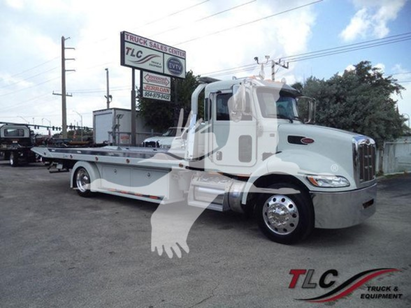 Peterbilt 337 rollback truck in beige/gray, side view with flatbed, chrome wheels, emblem on door, TLC Truck & Equipment logo watermark.