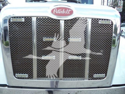 Peterbilt 337 grille and emblem with chrome surround and mesh, showing front view of truck grill and Peterbilt logo.