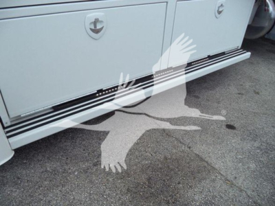 Peterbilt 337 rollback side skirt and lower step with storage compartments and emblem visible