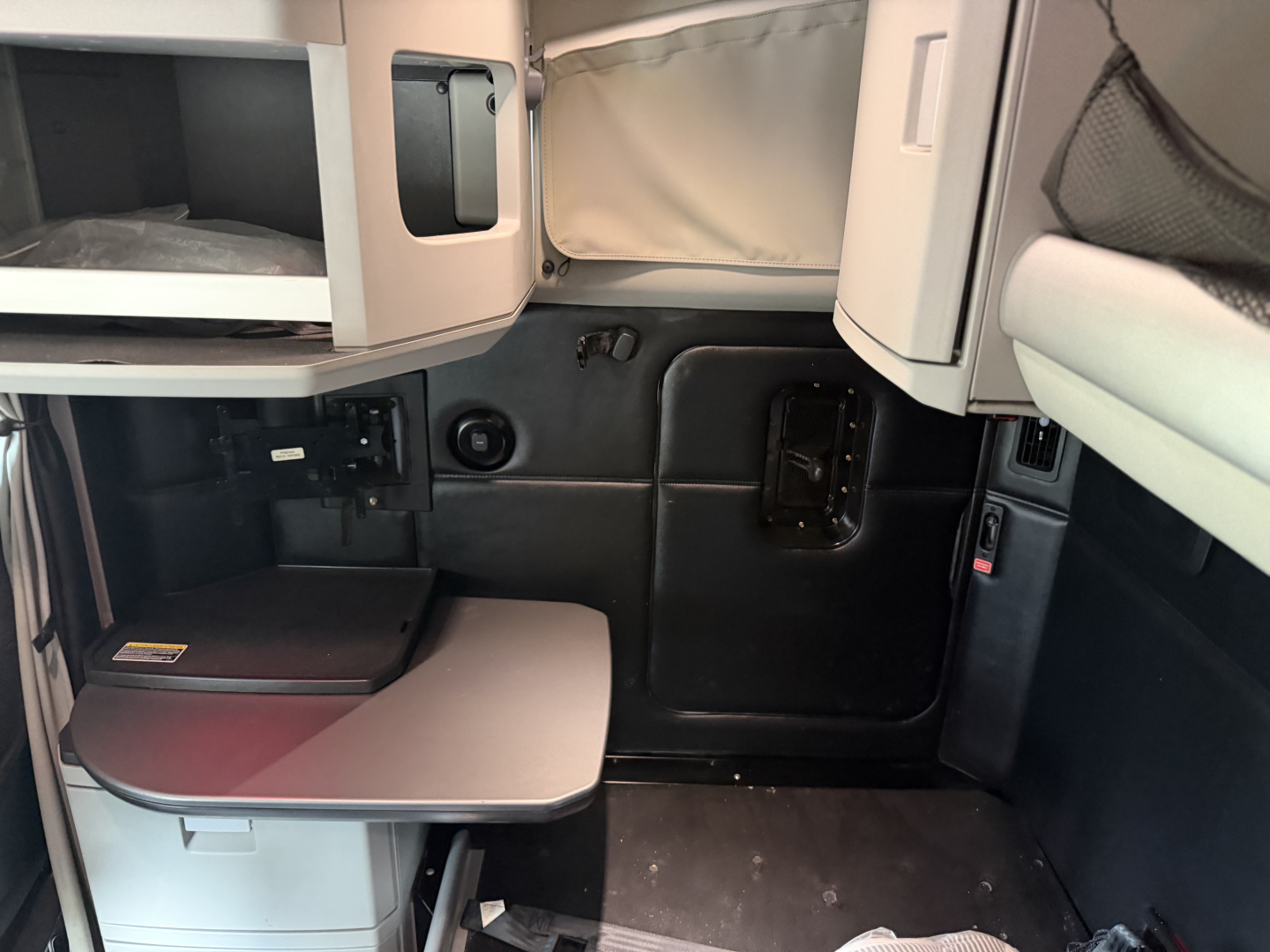 Kenworth T680 cab interior view showing sleeper area and storage compartments.