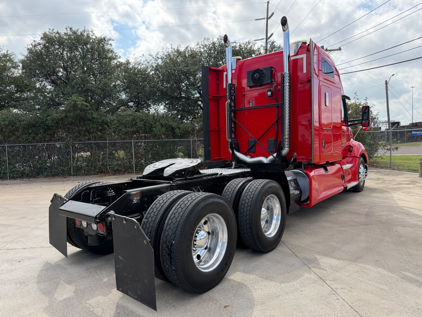 Kenworth T680 tractor show rear and side view with red cab and dual rear axles.
