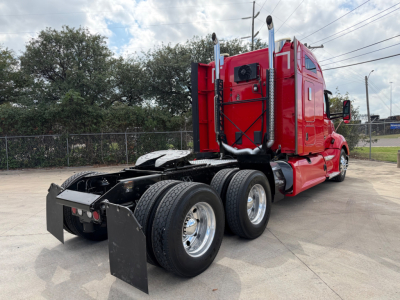 Kenworth T680 tractor show rear and side view with red cab and dual rear axles.