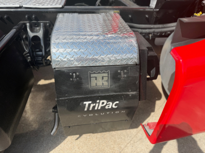 Kenworth T680 undercarriage with TriPac Evolution battery box and diamond plate cover visible.