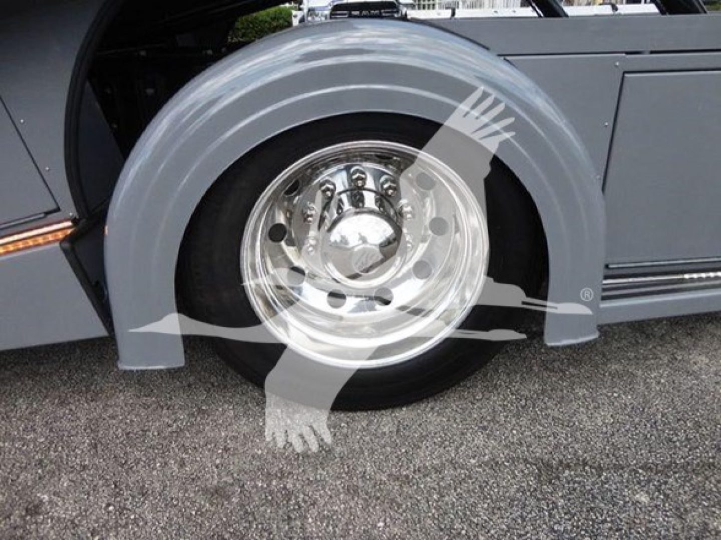 Peterbilt 337 rollback truck wheel and fender area showing chrome hubcap and gray wheel well.