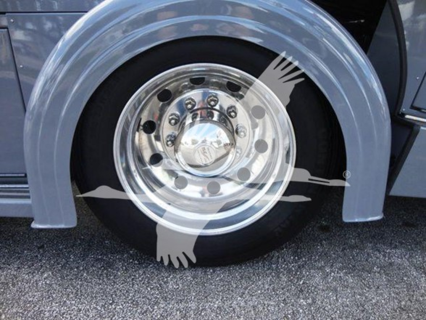 Peterbilt 337 rollback truck wheel and chrome hubcap with fender shows alloy wheel and tire.