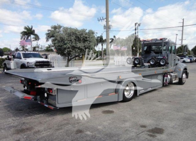 2022 Peterbilt 337 rollback truck in daylight showing flatbed and cab with towing equipment; VIN 2NP2HM6X9NM804653 visible in listing.
