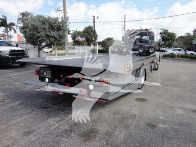 Peterbilt 337 rollback tow truck rear view showing flatbed and dual rear lights.