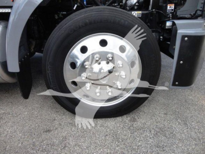 Peterbilt 337 wheel and front fender showing aluminum hub with multiple lug nuts and tire, part of rollback truck.