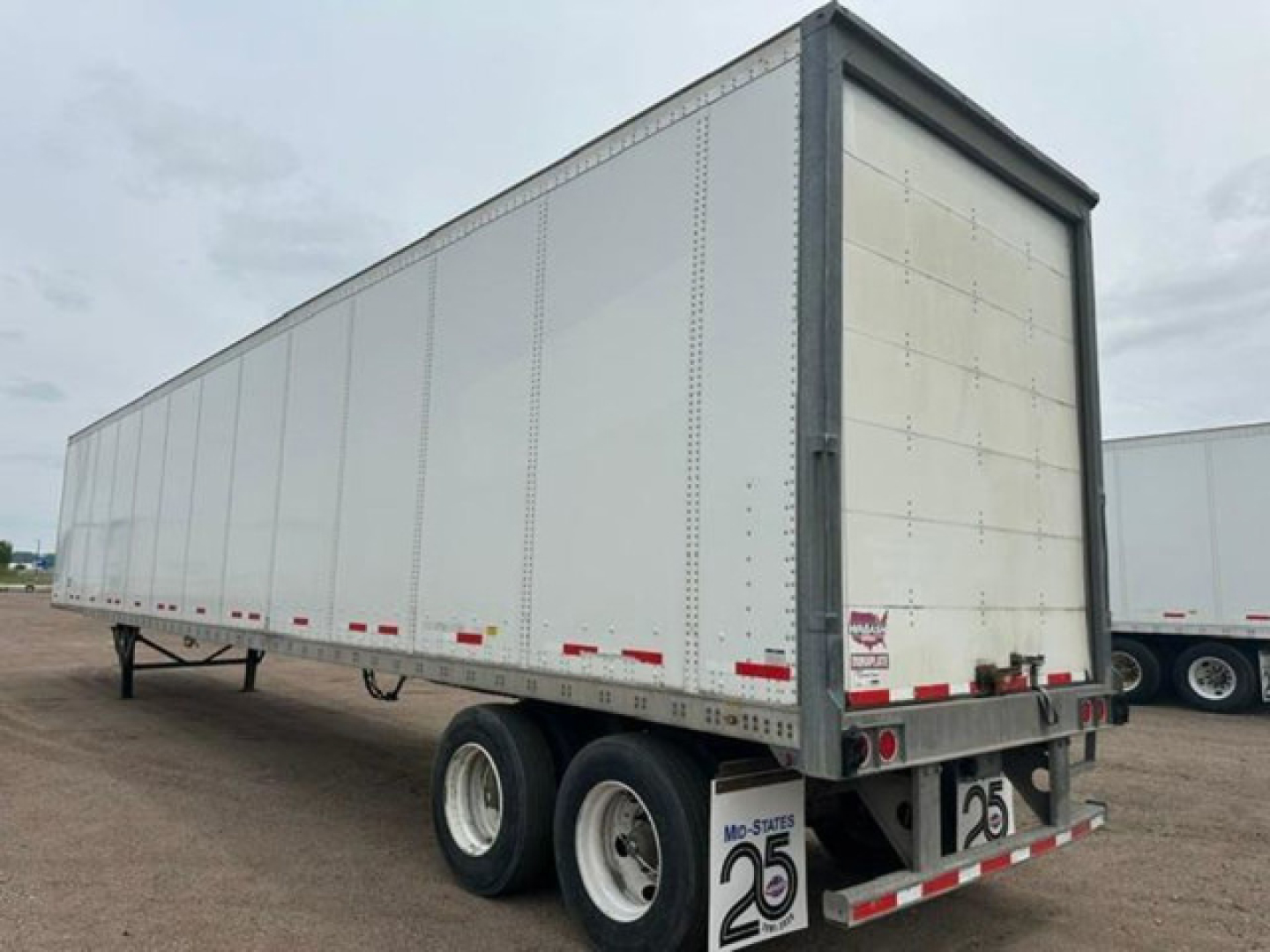 Trailer side and rear view of a used 2016 Wabash van trailer with white exterior, dual rear tires, and rear doors closed. VIN 1JJV532D8GL908642 visible on listing.