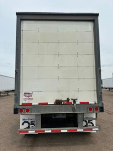 Rear view of a used 2016 Wabash van trailer showing closed rear doors, bumper, taillights, and reflective tape.