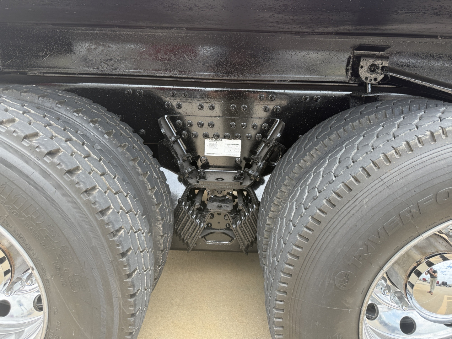 Mack GR64F truck rear axle area showing dual rear wheels and suspension components with a central frame member.