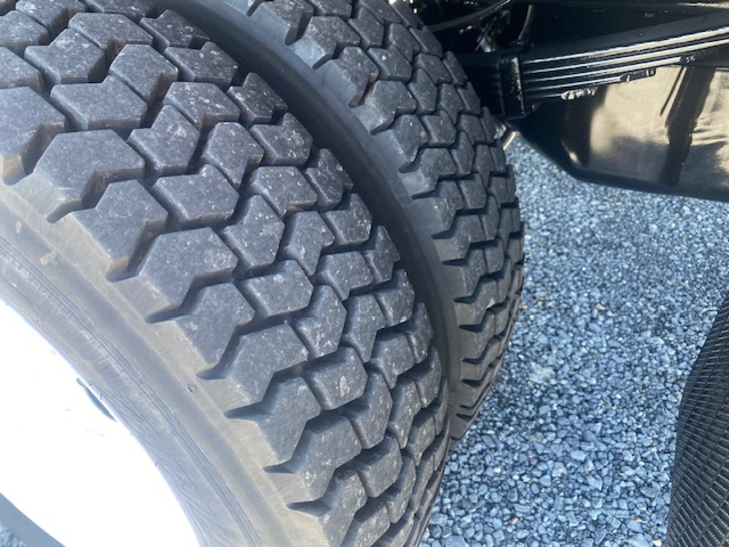 Ford F-550 wheel and dual-tire configuration showing tread detail and part of the chassis