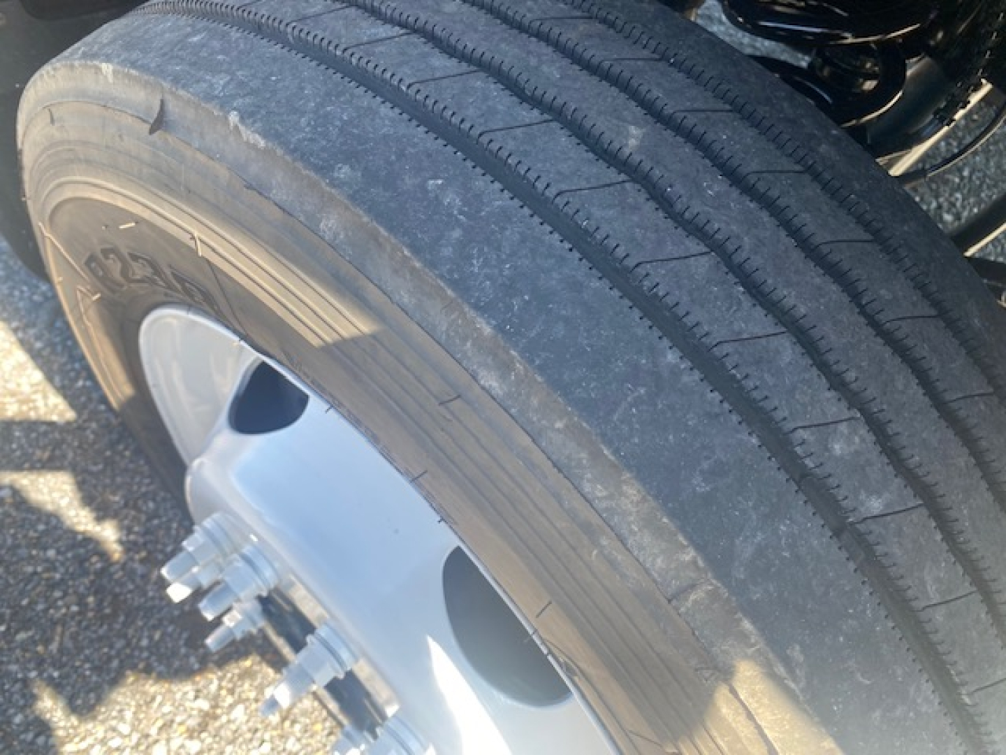 Ford F-550 wheel and tire close-up showing wheel hub and lug nuts.