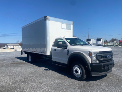 Ford F-550 box truck in-service showing large box cargo area and front grille; no visible text on the truck, basic white cab with black bumper.