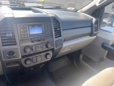 Ford F-550 cab interior showing dashboard, center console with touchscreen, climate controls, and steering area.