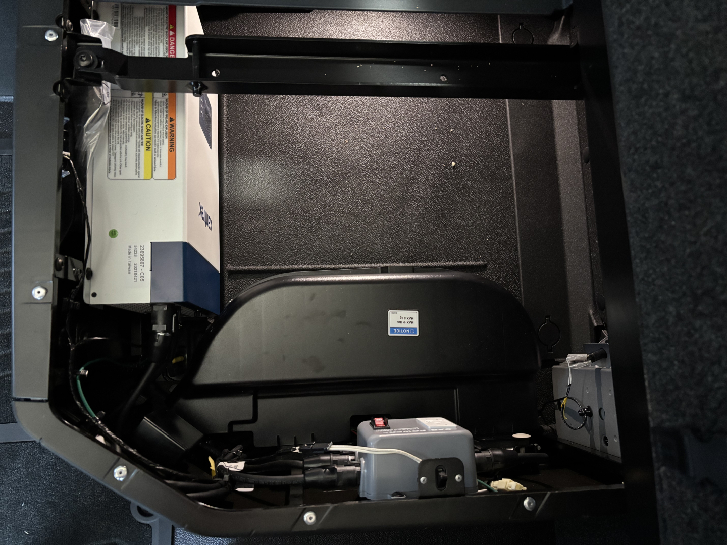 Volvo VNL64T860 sleeper cab truck interior showing battery and electrical components with label stickers.