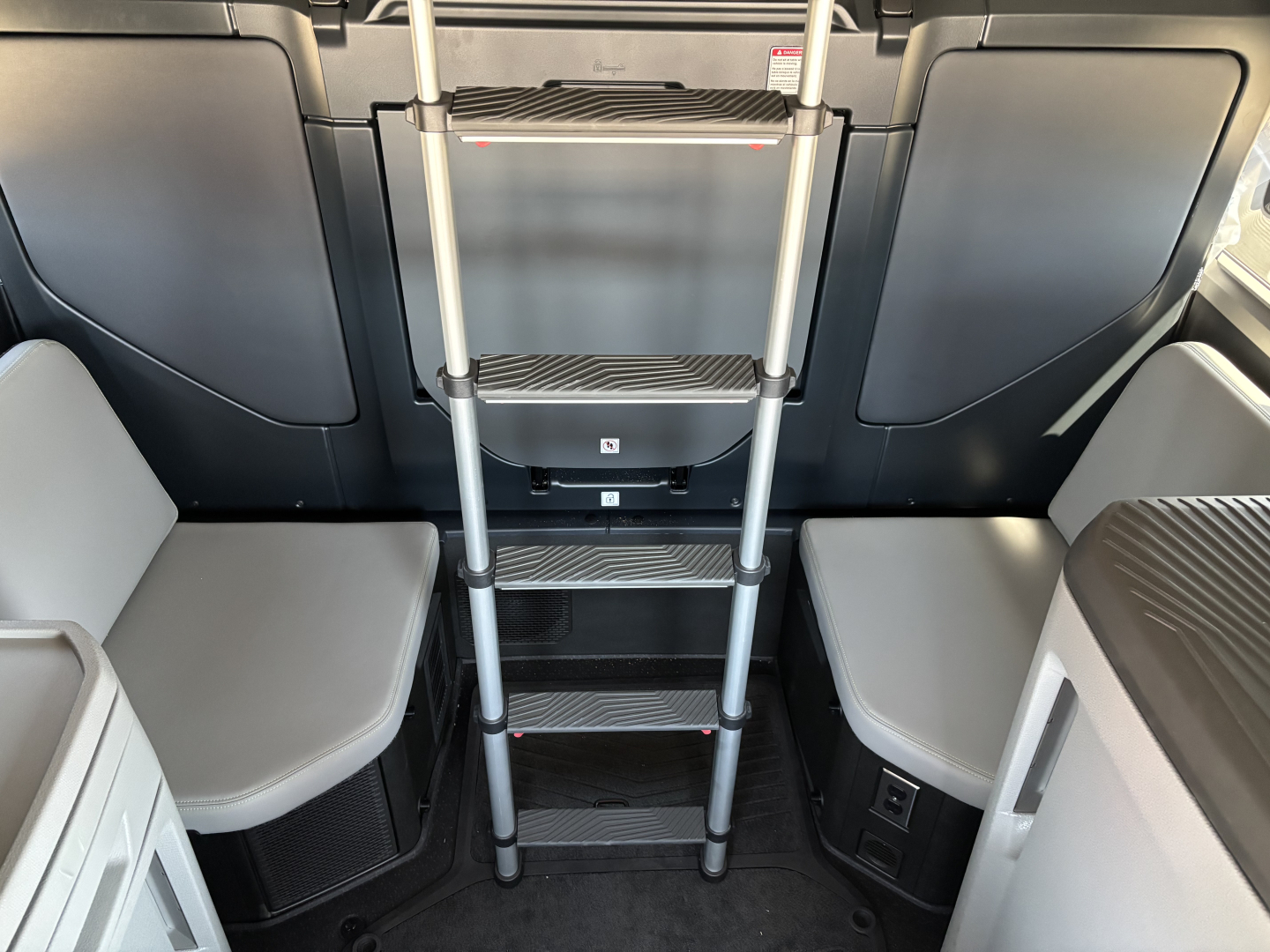 Volvo VNL64T860 cab interior showing vertical ladder with steps and seating areas on both sides.