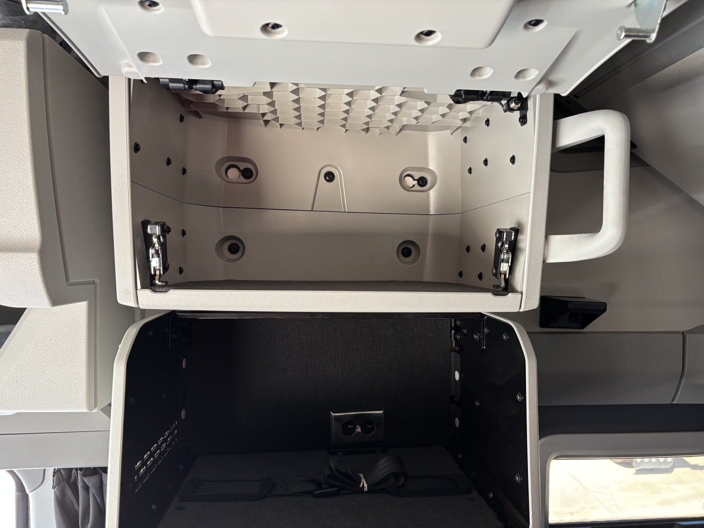Volvo VNL64T860 cab interior showing overhead storage compartments and dash area.