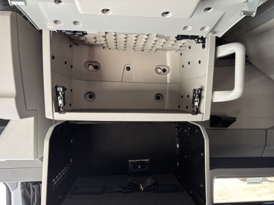 Volvo VNL64T860 cab interior showing overhead storage compartments and dash area.