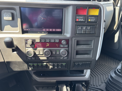 Volvo VNL64T860 truck cabin dashboard with tablet display, climate controls, and multiple switches; visible labels include various warning and function buttons.