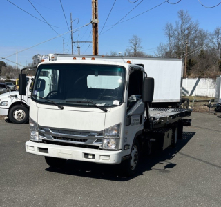 Isuzu NRR box truck side and front view showing cab with windshield, headlights, and a white box body in a parking lot.