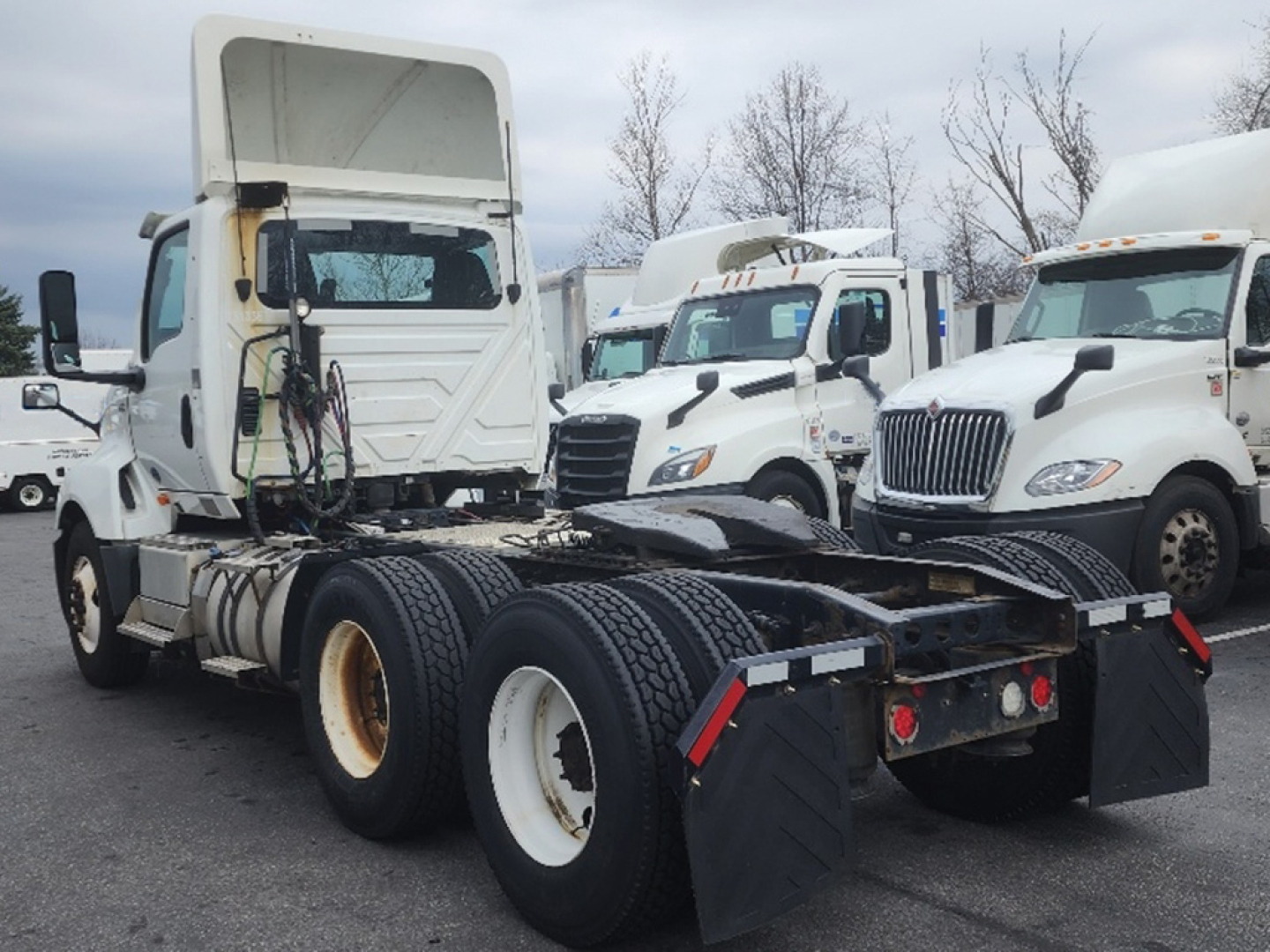 Truck chassis from a 2018 International LT625 with fifth wheel removed, dual rear axles, white wheels, and cab in the background.