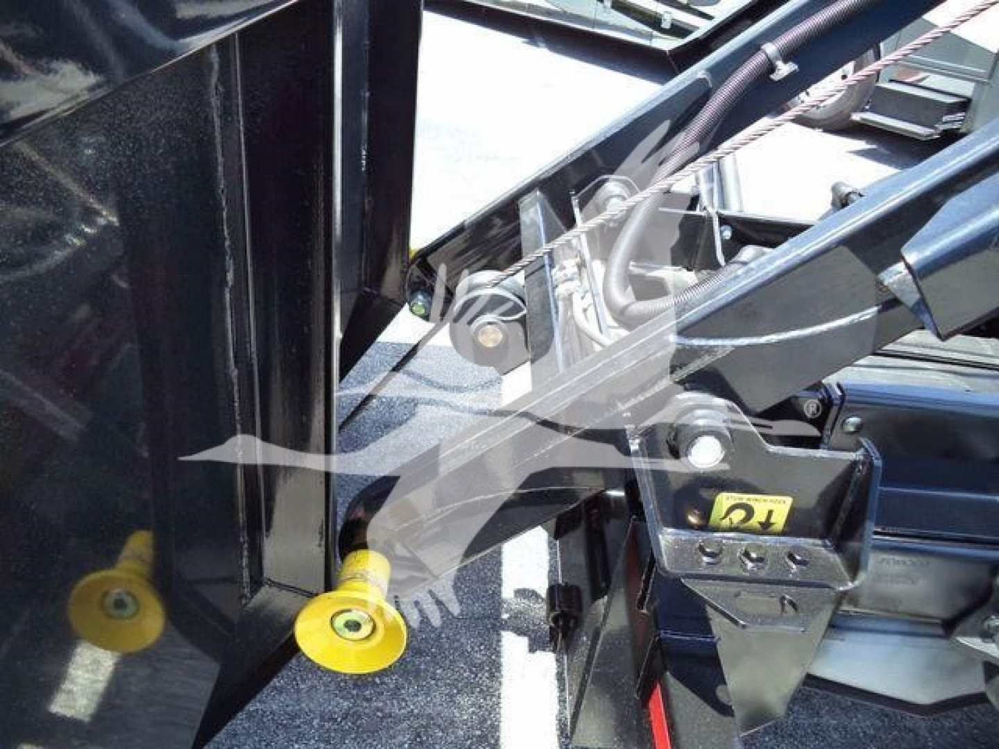 Ford F-550 rolloff truck cab area showing hydraulic controls and yellow protective caps on inlet fittings.
