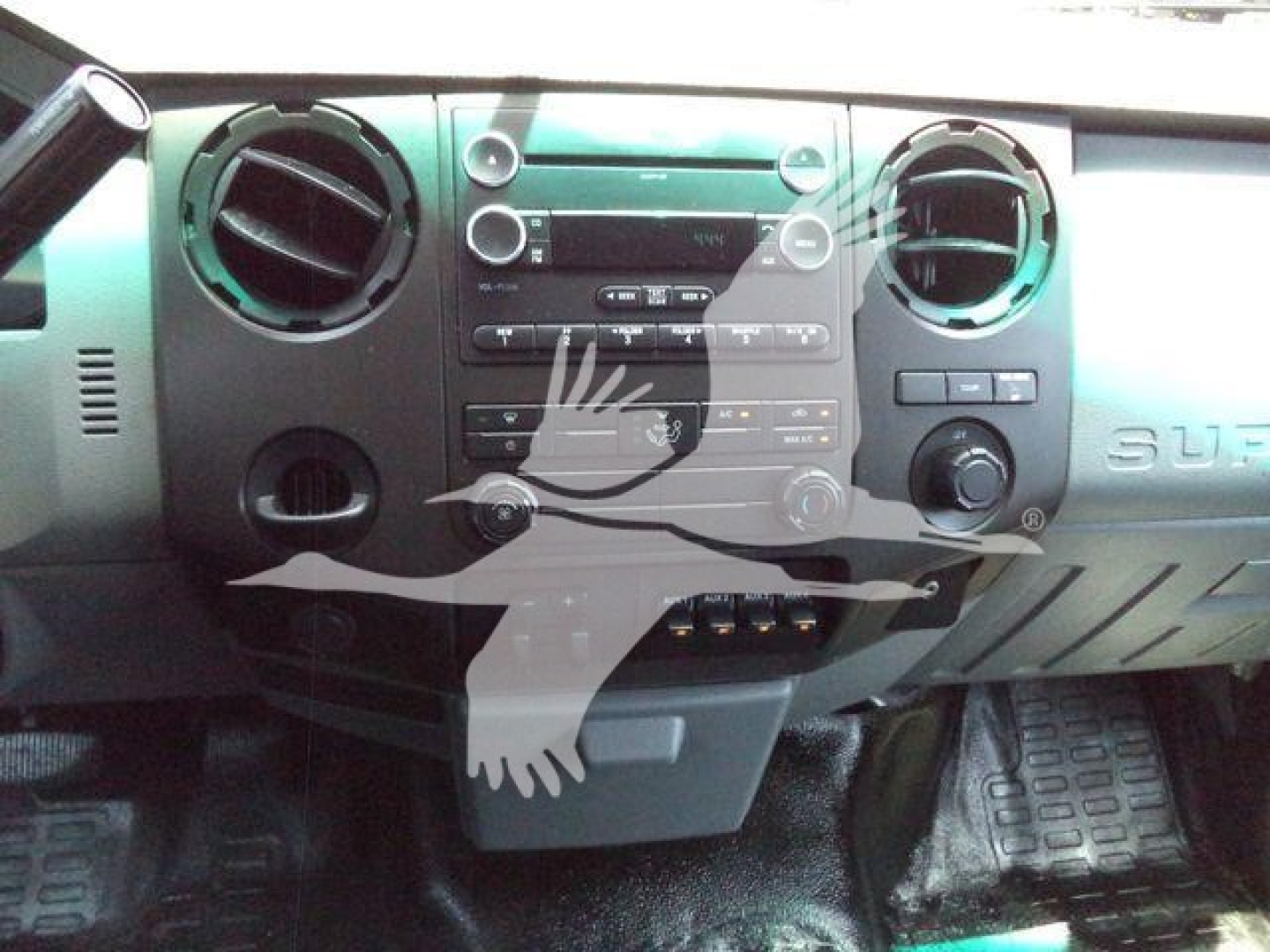 Ford F-550 interior dashboard view showing center console and climate controls.