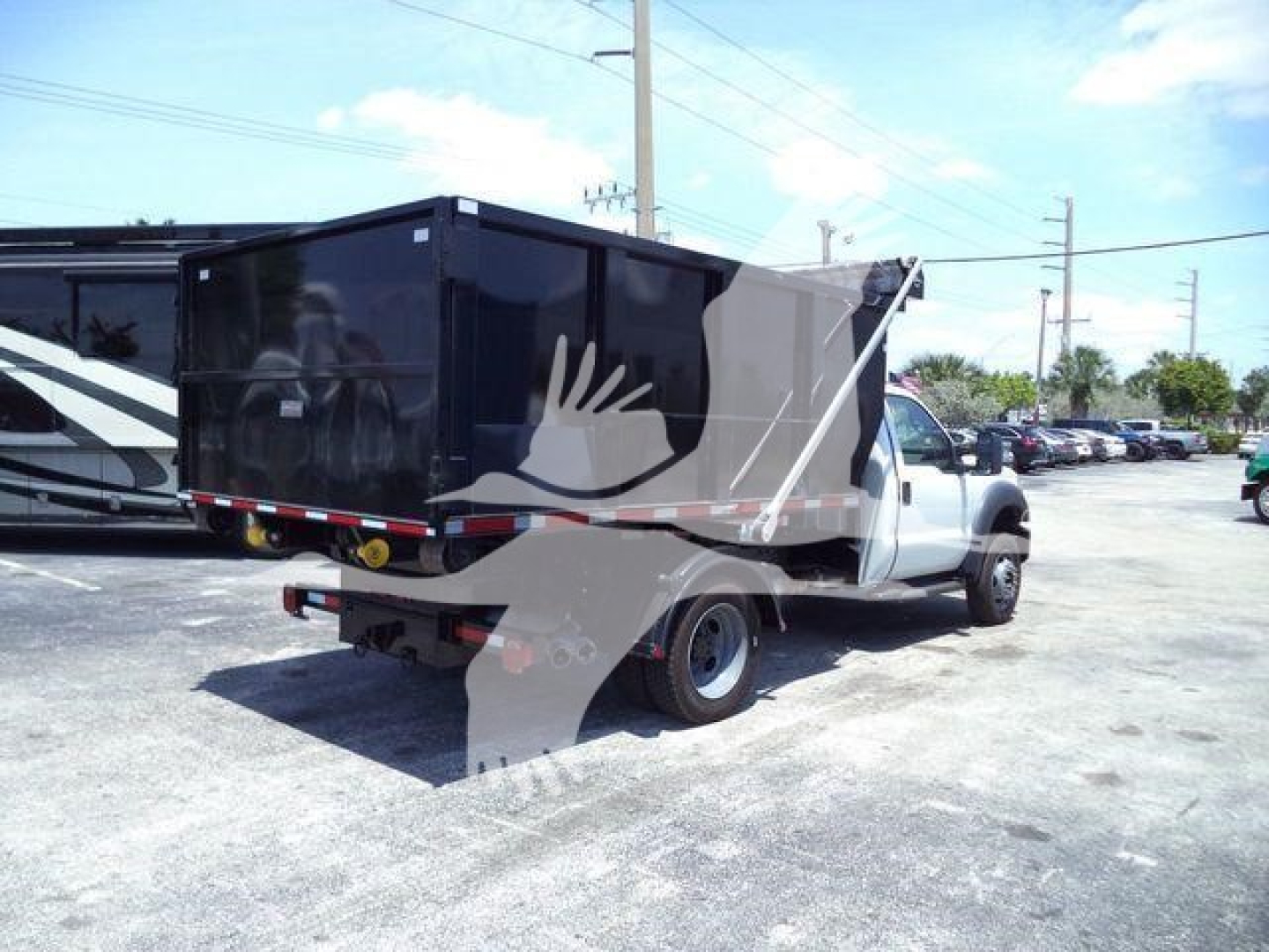 Ford F550 roll-off truck in-service showing cargo bed and rear view with backup lights