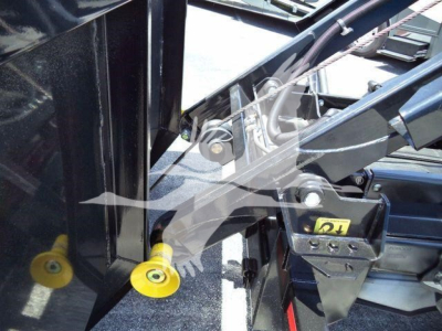 Ford F-550 rolloff truck cab area showing hydraulic controls and yellow protective caps on inlet fittings.