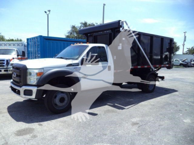 Ford F-550 dump truck in a lot, front cab, black dump bed, with watermark overlay. Visible text on the truck includes Ford emblem on grille.