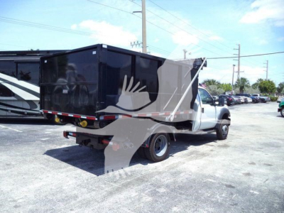 Ford F550 roll-off truck in-service showing cargo bed and rear view with backup lights