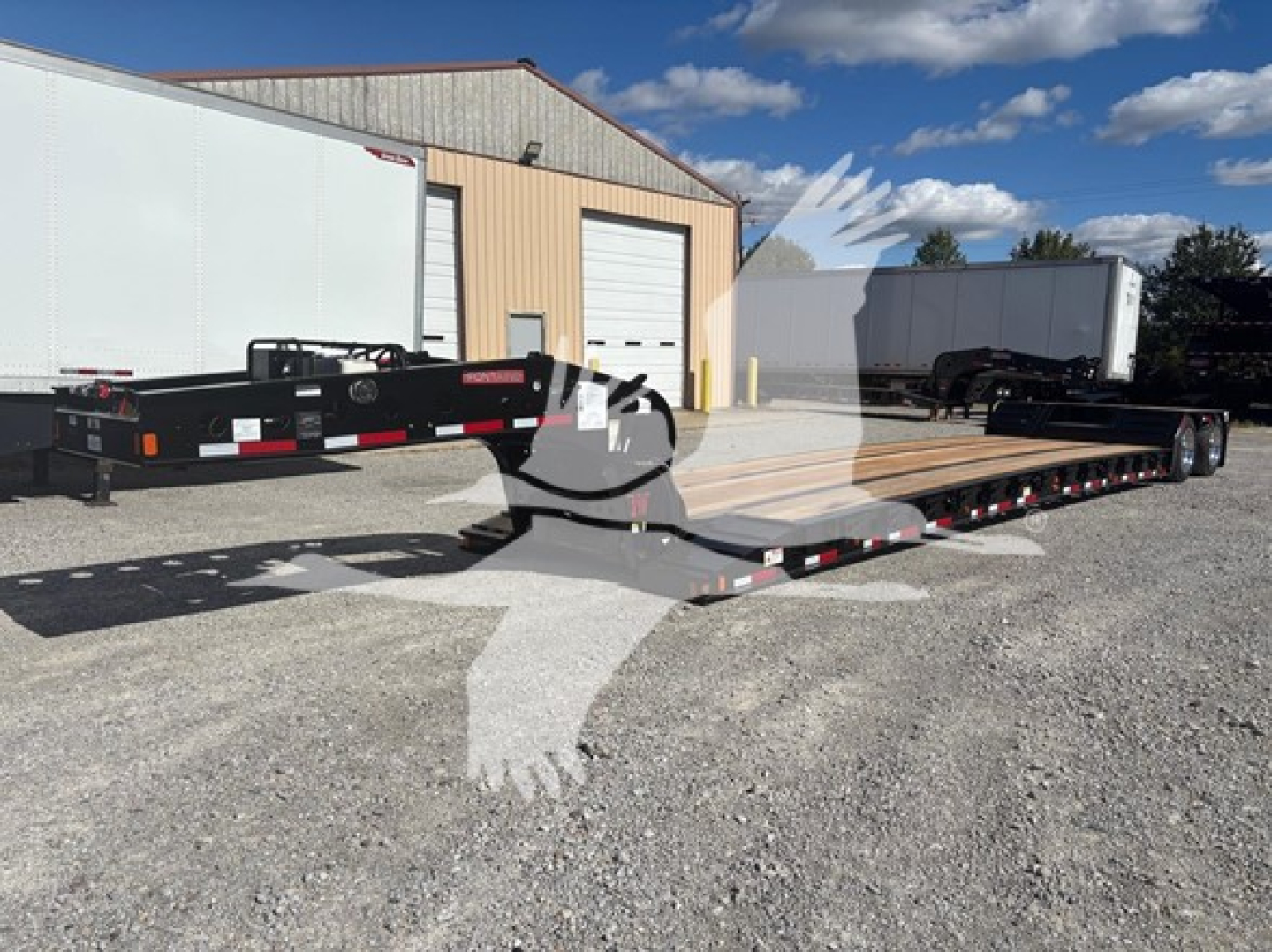 Fontaine N20 lowboy trailer with pony motor showing long deck and gooseneck front, black frame, white trailer jack, and loading ramps.