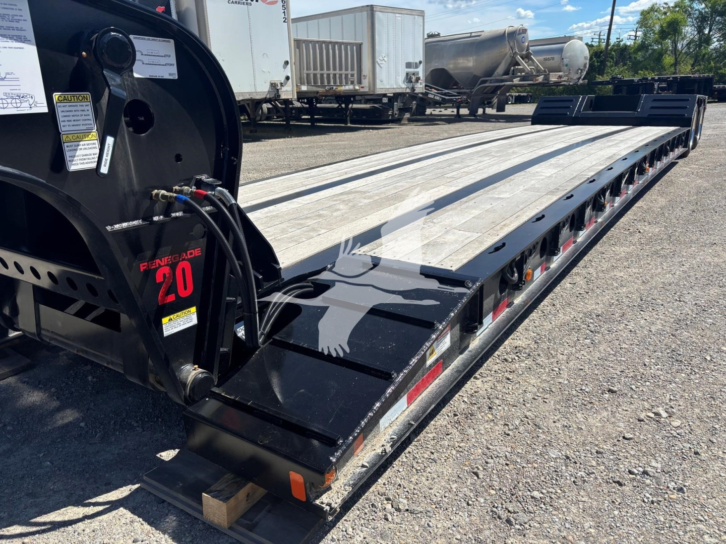 Fontaine Renegade N20 lowboy trailer showing landing gear and side deck with 'Fontaine Renegade 20' label and equipment hoses near front corner.