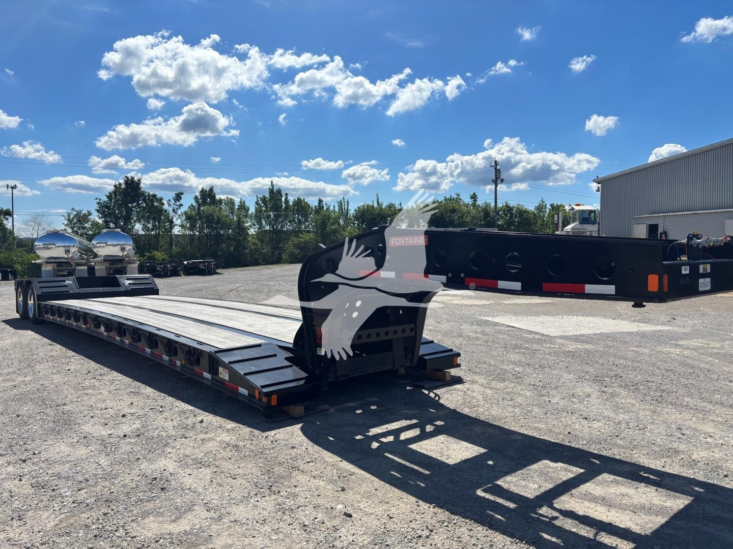 Lowboy trailer with Fontaine Renegade N20 logo showing flat deck and gooseneck in view.