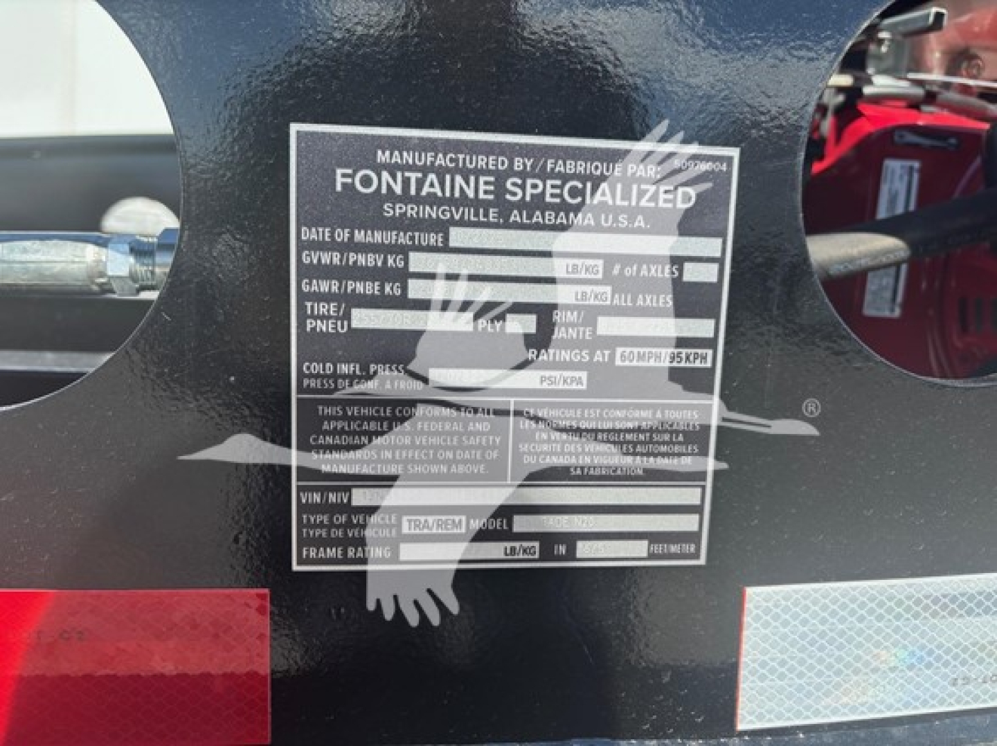 Trailer identification plate on Fontaine Specialized lowboy showing model/manufacturer details and blank fields for serials and weights.