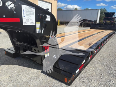  Fontaine N20 lowboy trailer with pony motor showing wooden deck, black frame, and ramp sections; stock label and VIN plate visible; reflective safety decals.