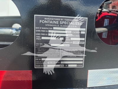 Trailer identification plate on Fontaine Specialized lowboy showing model/manufacturer details and blank fields for serials and weights.
