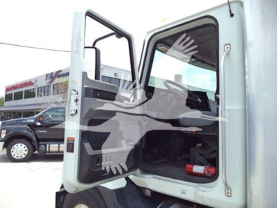 Box truck cab interior visible through open door showing steering wheel and dashboard with VIN 1M2MDBAB3PS071396