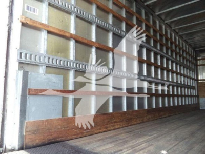 Truck trailer interior showing metal side walls and wooden floor with a watermark graphic across the image.