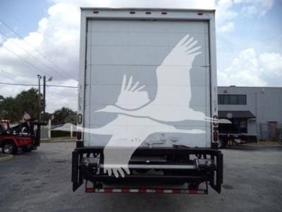 Rear view of a Mack MD7 box truck showing a large graphic of white birds on the back doors, with bumper and underride guard visible.