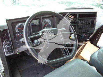 Mack MD7 cabin interior showing steering wheel and dashboard gauges.