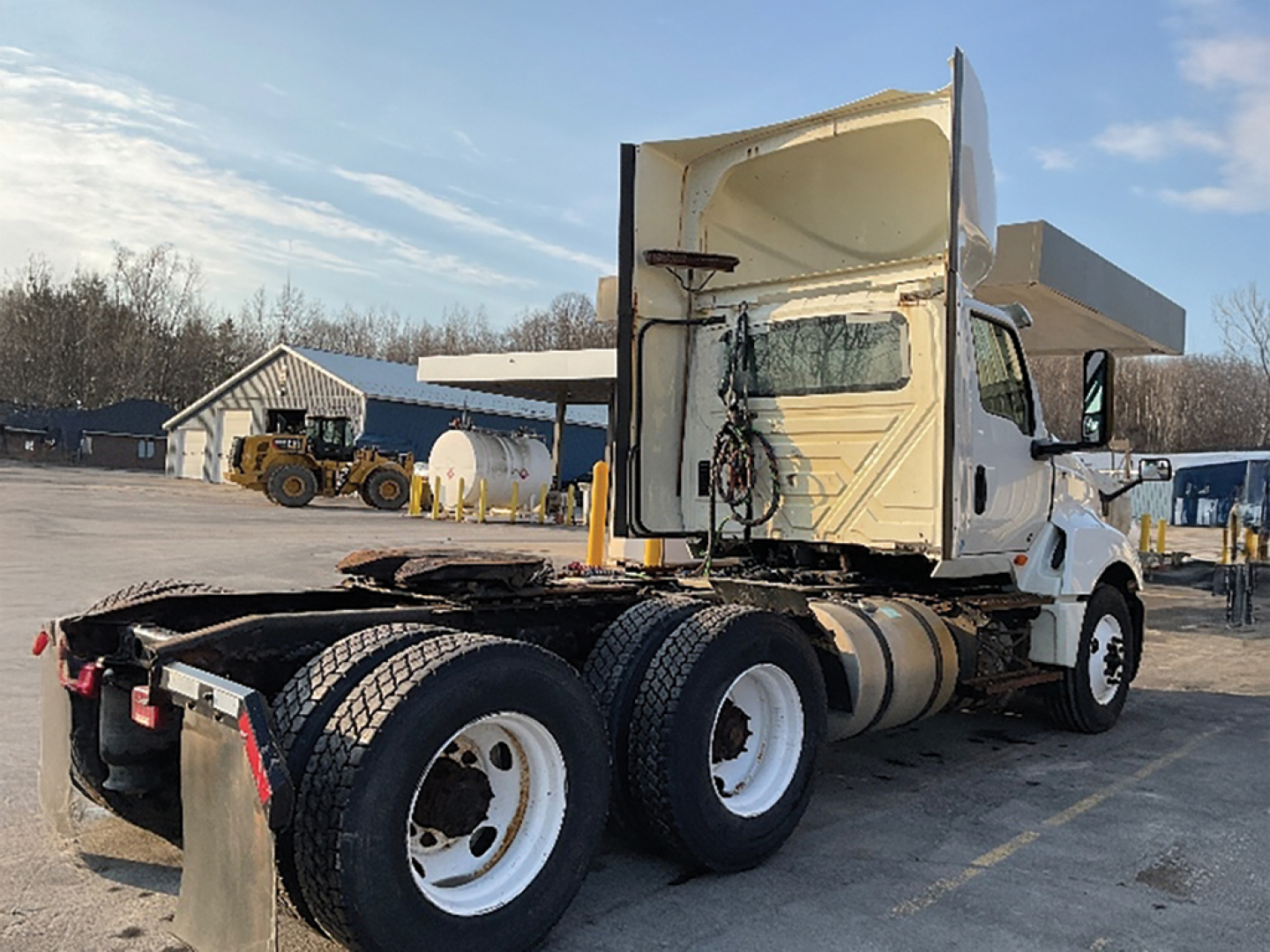 International LT625 daycab showing rear chassis with dual rear axles and white cab.