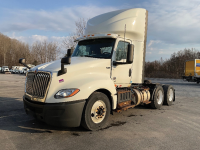 Truck cab and engine bay area showing International LT625 logo, 6x4 axle configuration, sleeper cab, fuel tanks, and wheel fenders.