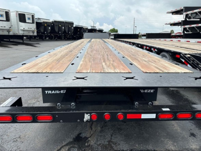 Trail-Eze TE801 trailer bed with wooden planks and black steel frame, rear view showing taillights, latches, and 'TRAIL-EZ' branding on the back
