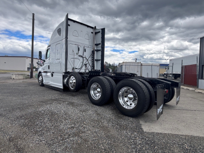 Freightliner CA-126 conventional sleeper tractor showing chassis and wheel configuration with dual rear axles and fifth-wheel area.
