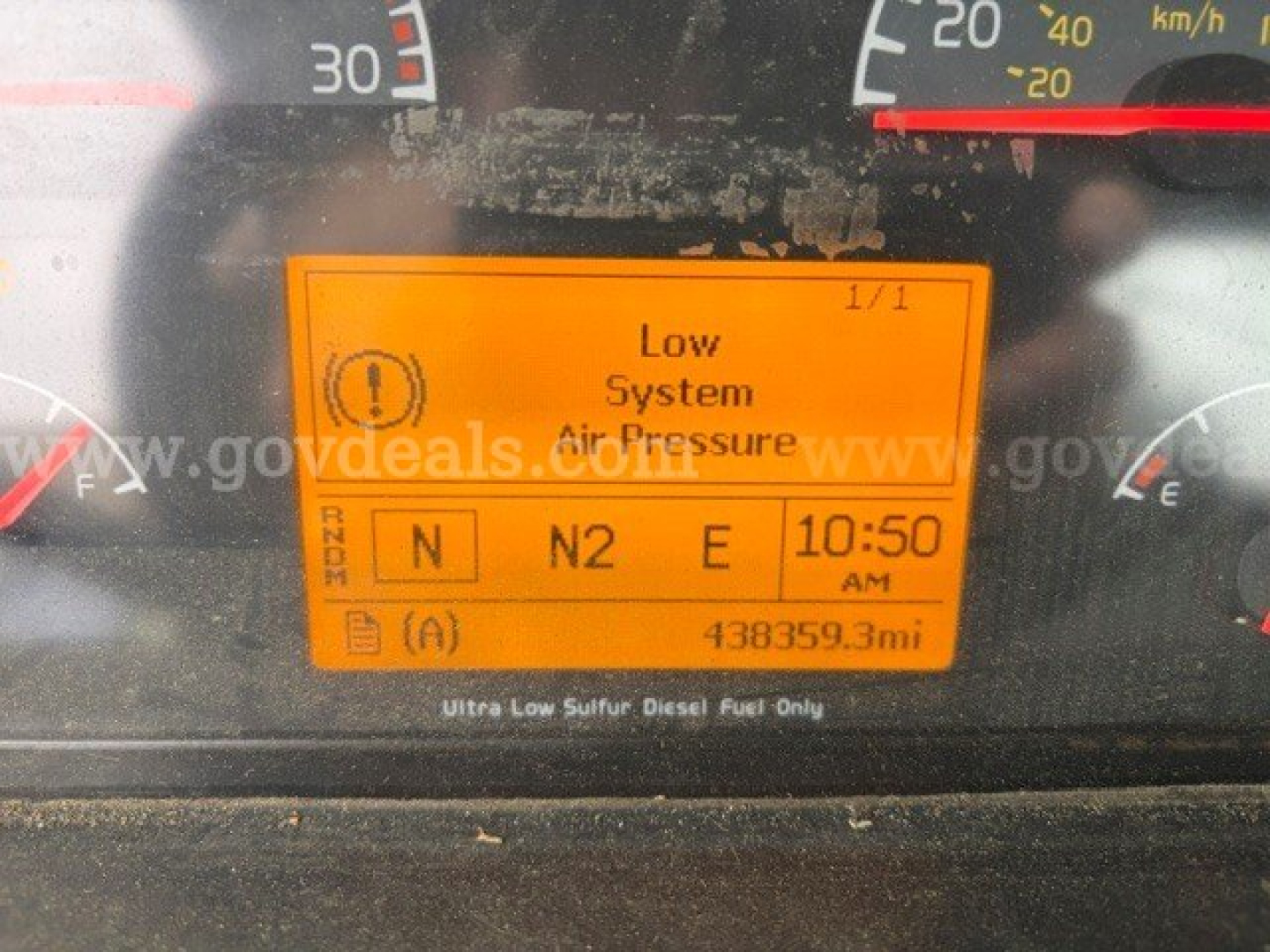 Volvo VHD dashboard showing Low System Air Pressure warning on orange display with N N2 E selection and 10:50 AM, odometer 43859.3 mi.